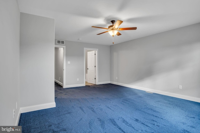 empty room featuring dark colored carpet and ceiling fan