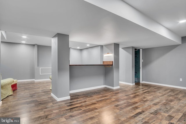 basement with dark hardwood / wood-style flooring