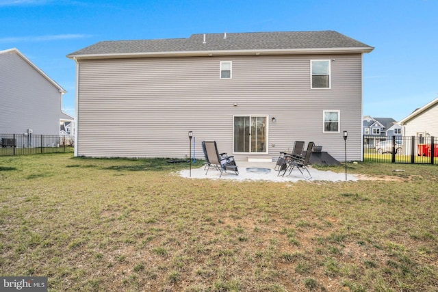 rear view of house featuring a yard and a patio