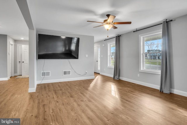 unfurnished living room with light wood-type flooring and ceiling fan