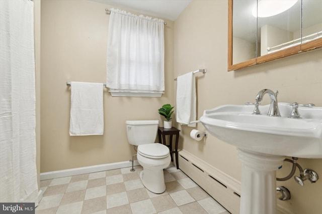 bathroom with toilet and a baseboard heating unit