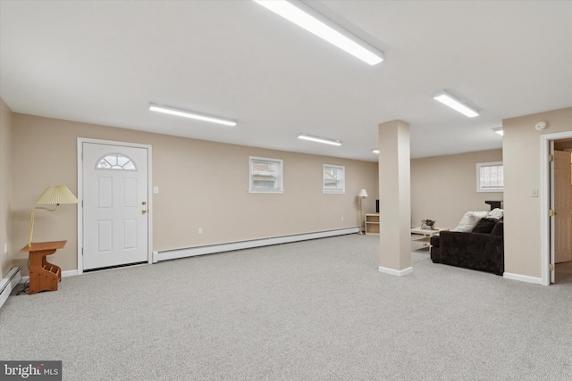 basement with light colored carpet and baseboard heating