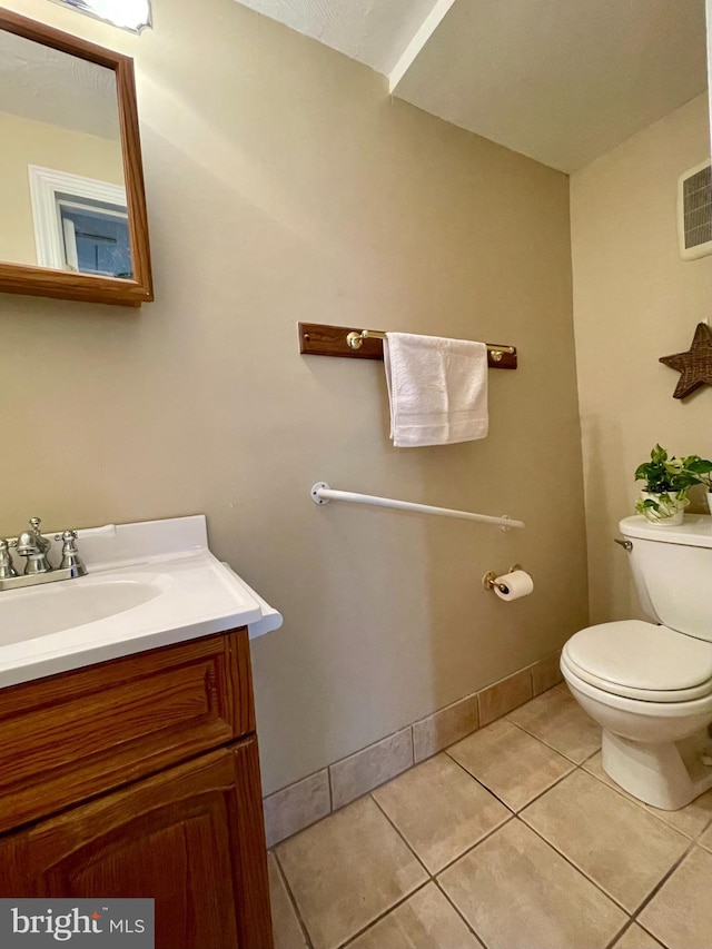 bathroom featuring tile patterned floors, vanity, and toilet