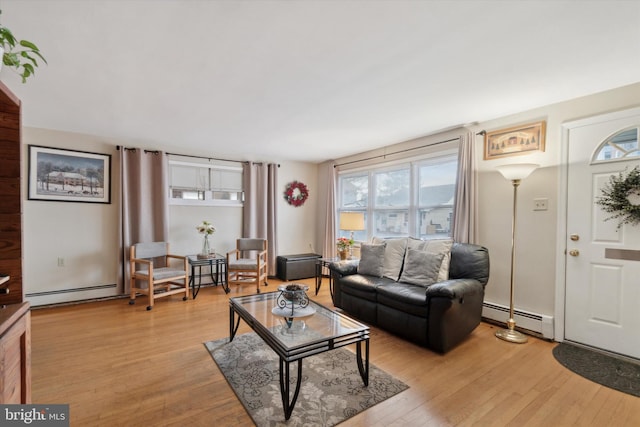 living room with light hardwood / wood-style floors and a baseboard heating unit