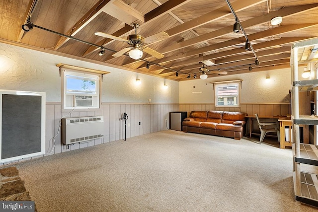 interior space with ceiling fan, cooling unit, wooden ceiling, and heating unit