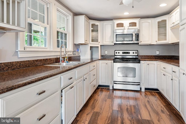 kitchen featuring dark hardwood / wood-style floors, white cabinetry, white electric range, and sink