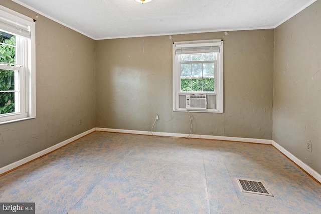 unfurnished room with ornamental molding, a wealth of natural light, and cooling unit