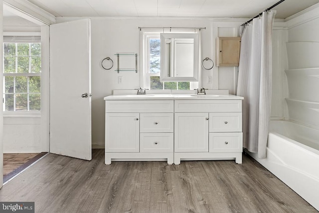 bathroom with plenty of natural light, shower / bath combination with curtain, and wood-type flooring