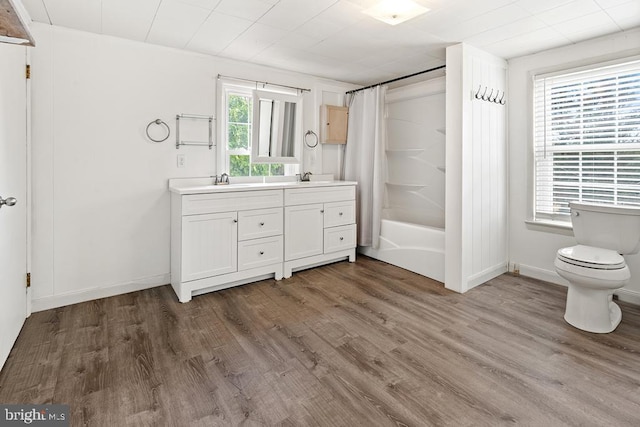 full bathroom featuring hardwood / wood-style flooring, a wealth of natural light, and shower / bathtub combination with curtain