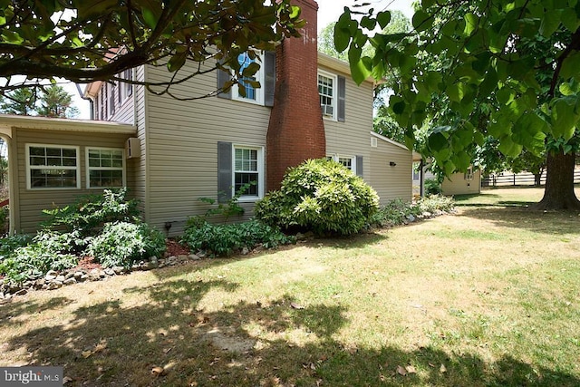 view of home's exterior featuring a lawn