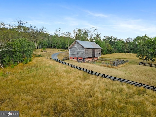 view of yard featuring an outbuilding and a rural view