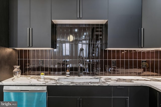 kitchen with light stone counters, tasteful backsplash, stainless steel dishwasher, and sink