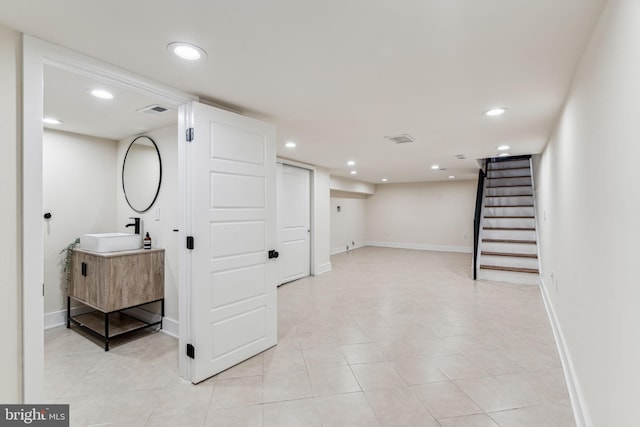 interior space with light tile patterned flooring and sink