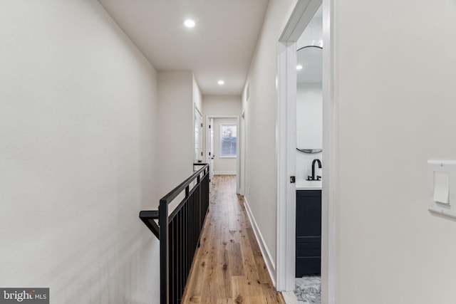 hallway with light hardwood / wood-style floors