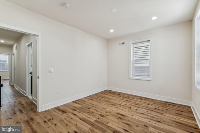 spare room with hardwood / wood-style flooring