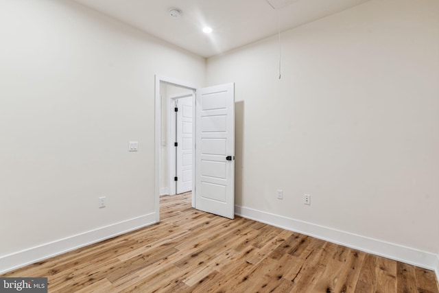 empty room with light hardwood / wood-style flooring