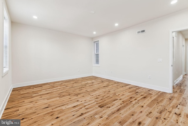 unfurnished room with light wood-type flooring