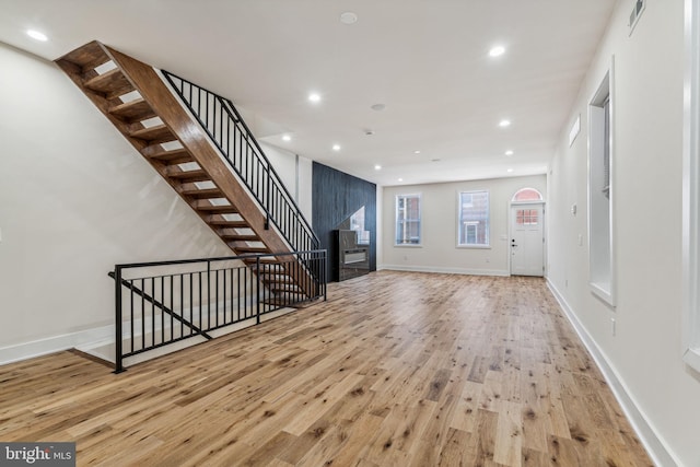 unfurnished living room with light hardwood / wood-style flooring