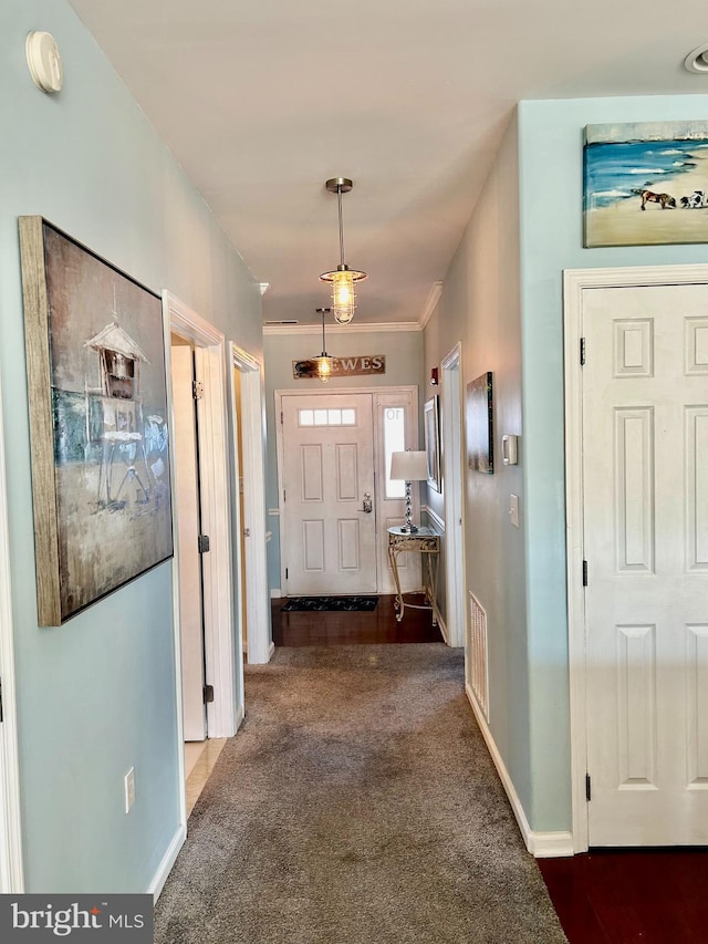 hallway featuring dark colored carpet