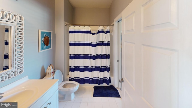 bathroom featuring toilet, vanity, a shower with curtain, and tile patterned floors