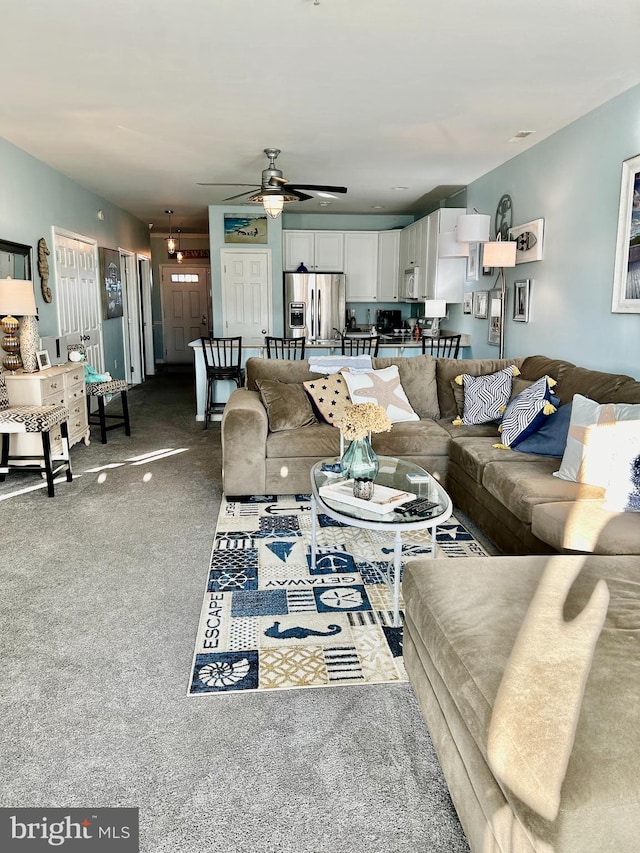 carpeted living room featuring ceiling fan