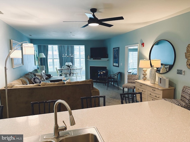 kitchen with ceiling fan and carpet floors