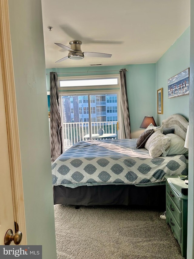 carpeted bedroom with ceiling fan and access to outside