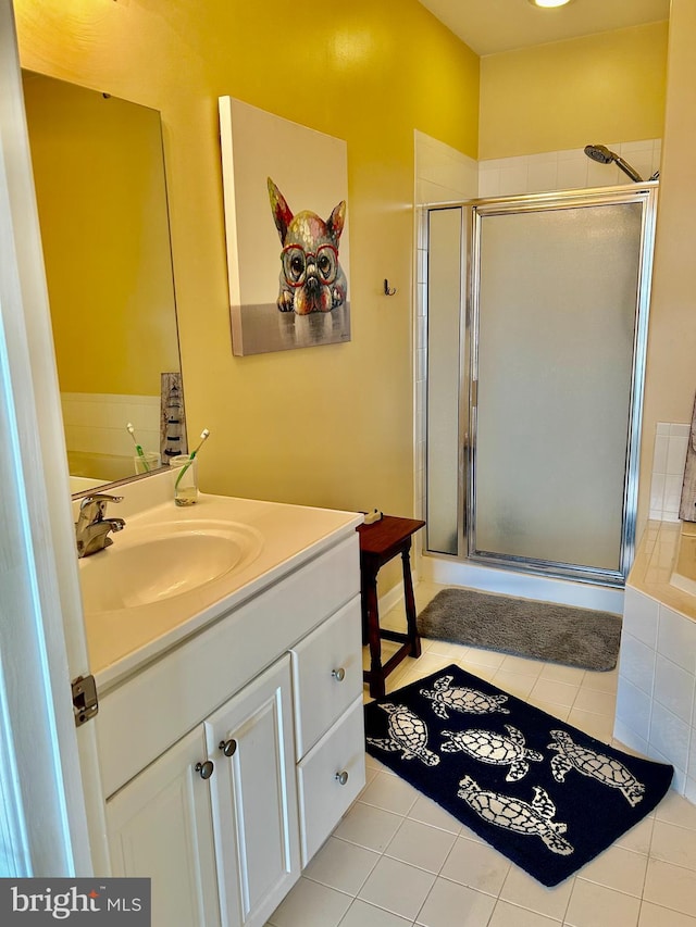 bathroom with tile patterned floors, separate shower and tub, and vanity