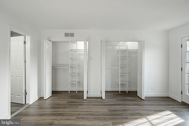 unfurnished bedroom featuring dark hardwood / wood-style floors