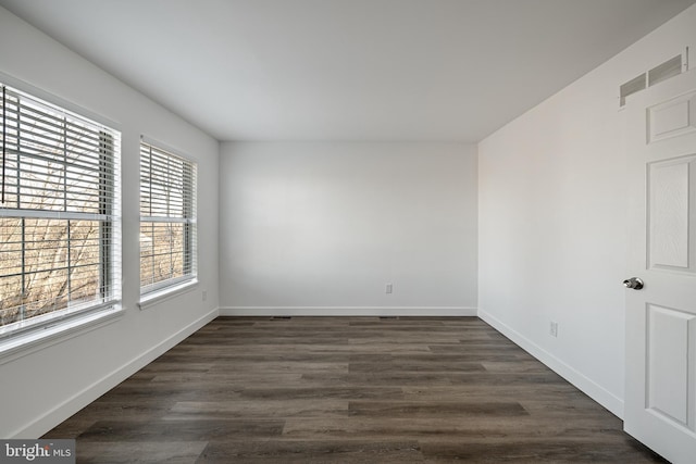 unfurnished room featuring dark wood-type flooring