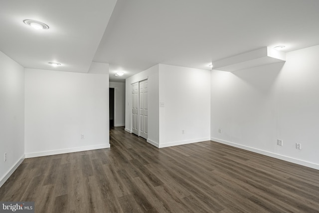 basement featuring dark hardwood / wood-style flooring