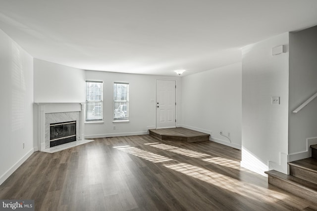 unfurnished living room with a fireplace and dark hardwood / wood-style flooring