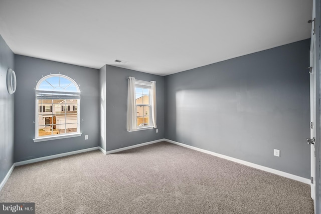 unfurnished room featuring carpet