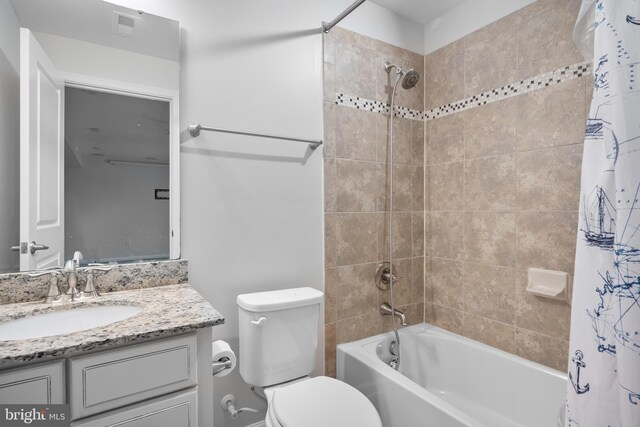 full bathroom featuring vanity, shower / bath combination with curtain, and toilet