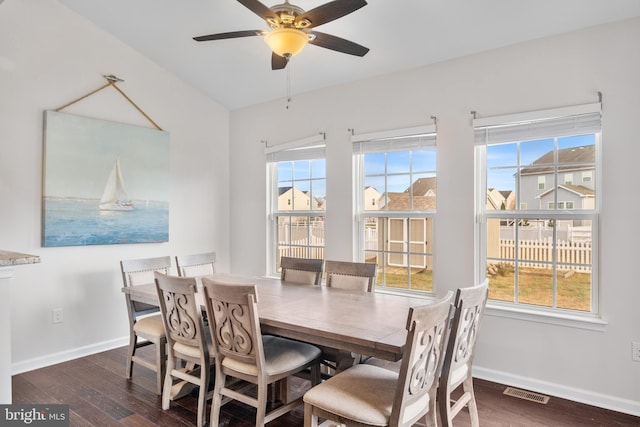 dining room with ceiling fan, dark wood-type flooring, and a wealth of natural light