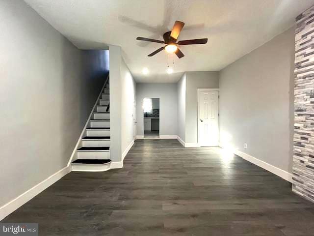 interior space with ceiling fan and dark hardwood / wood-style floors