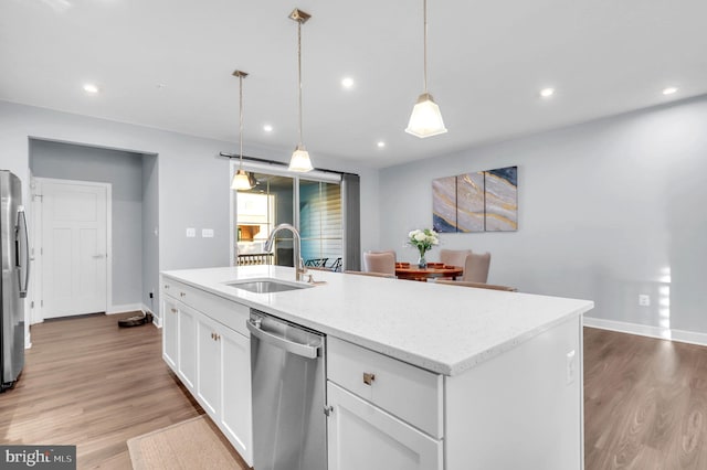 kitchen featuring white cabinets, light hardwood / wood-style floors, sink, and appliances with stainless steel finishes