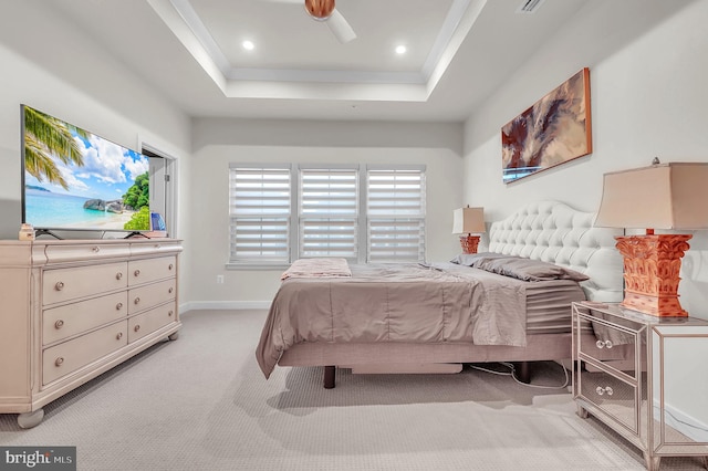 carpeted bedroom featuring a raised ceiling and ceiling fan