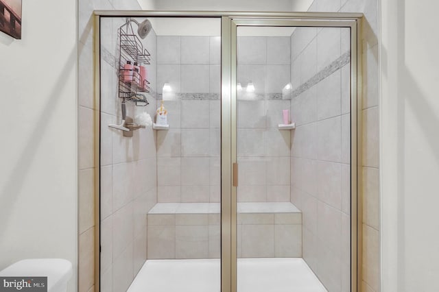 bathroom featuring a shower with door