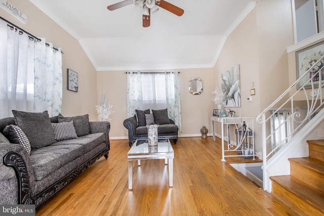 living room featuring ceiling fan, hardwood / wood-style floors, crown molding, and vaulted ceiling