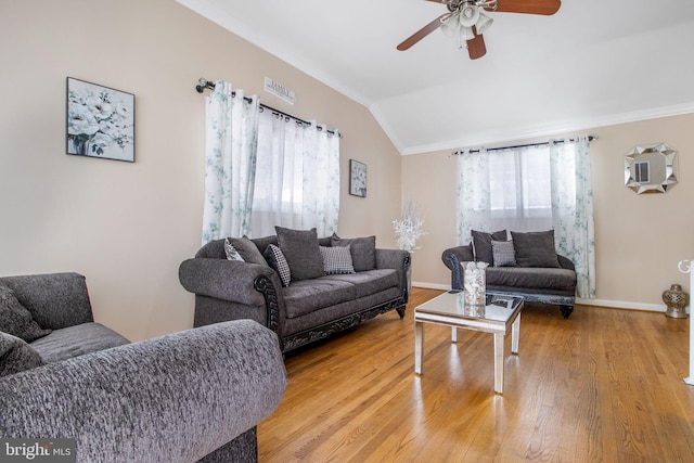 living room with ceiling fan, plenty of natural light, wood-type flooring, and lofted ceiling