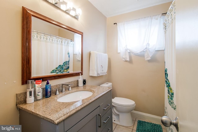 bathroom featuring tile patterned floors, vanity, and toilet