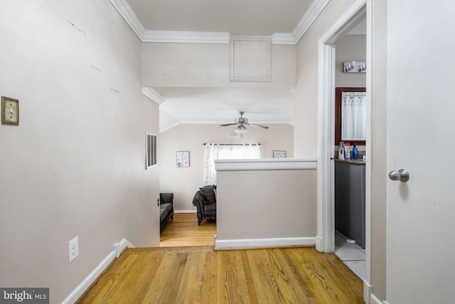 hallway featuring hardwood / wood-style floors and ornamental molding