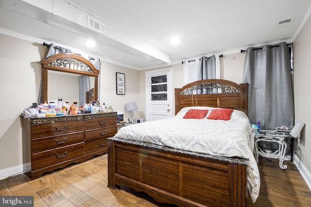 bedroom with hardwood / wood-style floors and ornamental molding