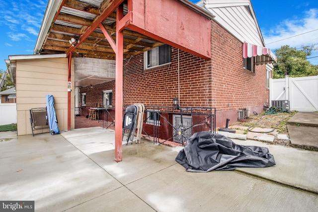 view of side of property featuring a patio and central AC unit