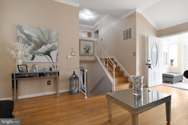 stairway featuring wood-type flooring and crown molding