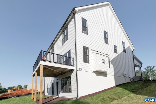 rear view of property with a yard, cooling unit, and a wooden deck