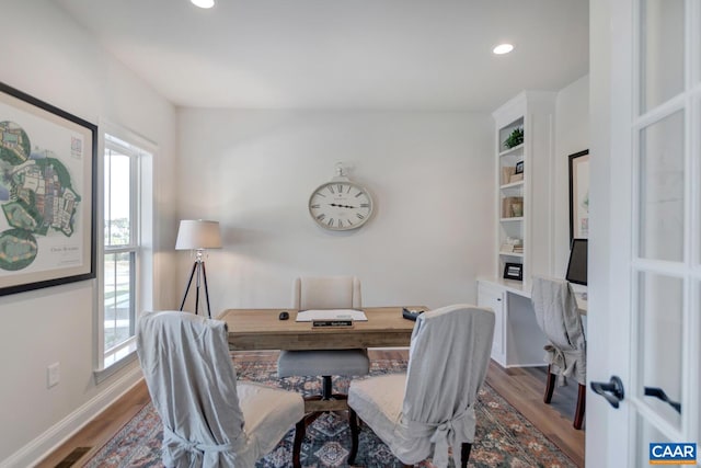 office space featuring a wealth of natural light and hardwood / wood-style floors