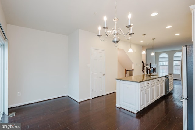 kitchen featuring recessed lighting, appliances with stainless steel finishes, dark wood-type flooring, white cabinetry, and a sink