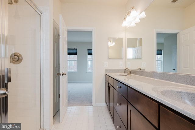 bathroom with tile patterned flooring, a sink, visible vents, a tile shower, and double vanity